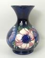 A Moorcroft pottery vase of baluster form decorated in the 'Anenome' pattern against a cobalt blue g... 
