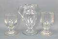 A George III glass water jug of baluster form, 21cm high, and two glass rummers, 14 and 16cm high.