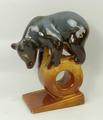 A USSR pottery figure of a bear modelled standing on a wheel and wedge shaped base, printed mark, 14... 