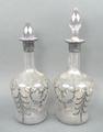 A pair of cut glass decanters and stoppers, late 19th century, with silver resist foliate and floria... 