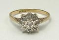 A gold and diamond flower head ring, of eight petals, size R, marks rubbed, 2g.