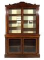 A William IV mahogany two section bookcase, the carved pediment above two glazed doors, enclosing si... 