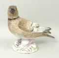 A German porcelain figure, 20th century, of a ring necked dove modelled on a rococo base, blue cross... 