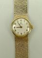 A lady's 9ct gold Omega wristwatch, circular dial bearing Arabic numerals, on a 9ct mesh gold strap,... 