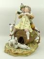 A Continental bisque porcelain figure group, late 19th century, modelled as a boy and girl atop a ca... 