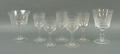 A near set of eleven dessert wine glasses, late 19th century, with geometric pattern engraving, elev... 