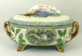 A Minton majolica twin handled game pie dish, cover and liner, the cover with hound finial, and hunt... 