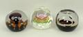 A group of Caithness glass paperweights comprising Ready Steady Go, Sunflower, and Christmas 1977. (... 