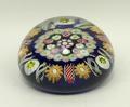 A Victorian concentric millefiori and twisted cane paperweight against a blue ground, 7.5cm diameter... 