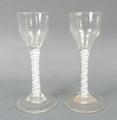 A pair of George III cordial glasses, circa 1780, the pan tops above a straight double opaque twist ... 