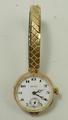 A 1930's lady's 9ct gold wristwatch, manual wind, circular ceramic dial bearing Arabic numerals with... 
