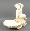 A Copeland porcelain table centrepiece, late 19th century, modelled as a putto atop a basket of frui... 