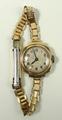 A Mimo lady's 9ct gold cased wristwatch, circular dial bearing Arabic numerals, on a rolled gold str... 