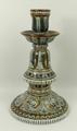 A Doulton Lambeth stoneware candlestick, circa 1876, with a bell shaped stem and conical foot design... 