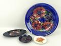 A Moorcroft pottery dish decorated in the 'Anenome' pattern against a blue ground, 21cm diameter, an... 