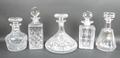 A group of glass decanters and stoppers, comprising a Baccarat faceted decanter of pear form, 24cm, ... 