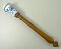 A 19th century blue and white ceramic kitchen implement, with turned beech handle, decorated in the ... 