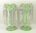 A pair of green glass lustres, late 19th century, with gilt leaf decoration, each hung with eight cl... 