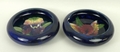 A pair of Moorcroft pottery dishes decorated in the 'Orchid' pattern against a blue ground, impresse... 