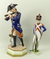 A Wallendorf porcelain figure of Frederich the Great, modelled standing against a stool playing the ... 