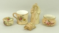 A group of Royal Worcester blush porcelain, comprising a candle snuffer modelled as Granny Snow, a t... 