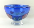 A Caithness blue glass bowl decorated with a pink rose design, 15cm high, 21cm diameter.