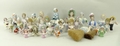 A quantity of porcelain pin cushion dolls, early 20th century, one with cushion and legs, two with b... 