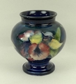 A Moorcroft pottery vase of baluster form decorated in the 'Orchid' pattern against a blue ground, i... 