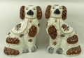 A pair of Staffordshire pottery spaniels, late 19th century, modelled with brown markings, 25cm high... 