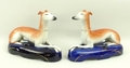 A pair of Staffordshire greyhound inkwells, late 19th century, modelled in recumbent pose on oval ba... 