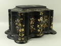 A Victorian papier mache twin division tea caddy of rectangular, serpentine form, painted and mother... 