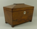 A Regency rosewood, sarcophagus form tea caddy, with gadrooned escutcheon to the top, mother of pear... 