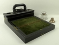 A Victorian ebony writing slop with slide handle and internal drawer, 32 by 25 by 20cm, a glass hexa... 
