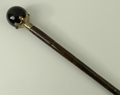 A bamboo walking stick, early 20th century, with a tiger's eye ball knop, in a plated crown mount, 8... 