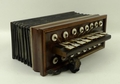 A Victorian accordion, with steel reeds, mother of pearl keys and concertina action, in original oak... 