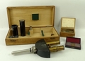 A Reichert hand held binocular microscope, no 665, further lenses, cased, and slides in two boxes.