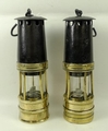 A pair of 19th century brass and iron miner's lamps, 28cm high.