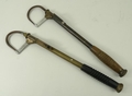A brass and cast iron salmon gaff with a turned wooden handle, and another similar, each 39.5cm long... 