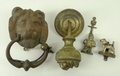 A brass lion's head door knocker, a door knob similarly cast, a cold painted wire haired terrier kno... 