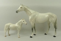 A Beswick pottery figure of a grey dappled hunter horse, no 1734, 29cm high, and a further dappled g... 