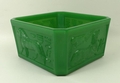 A 19th century pressed green glass table centre, of square form with canted corners and decorated wi... 