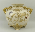 A Royal Worcester gilt blush ivory squat vase, late 19th century, the flaring neck leading to twin m... 