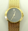 An 18ct gold lady's Rolex Cellini wristwatch, circular black dial with Roman numerals to the case be... 