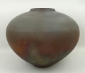 A Raku studio pottery vase, the ovoid body with oxidised iridescent glaze, 25cm high.
