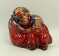 A Royal Doulton prototype flambe figure group, signed Noke, of embracing chimpanzees, painted in sun... 
