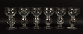 A set of six hand blown glasses, with knops containing hunting horses and riders, and hunting hounds... 