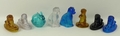 A group of Victorian coloured pressed glass figures, comprising four Derbyshire type lions, two seat... 