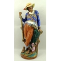 A Continental porcelain figure of a gentleman, with braided jacket, musket, shot flask and hunting b... 