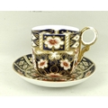 A Royal Crown Derby Imari pattern moustache cup and saucer, both marked to base 2451.