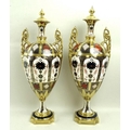 A pair of Royal Crown Derby twin handled urns, decorated in the 'Old Imari' pattern, on square base,... 